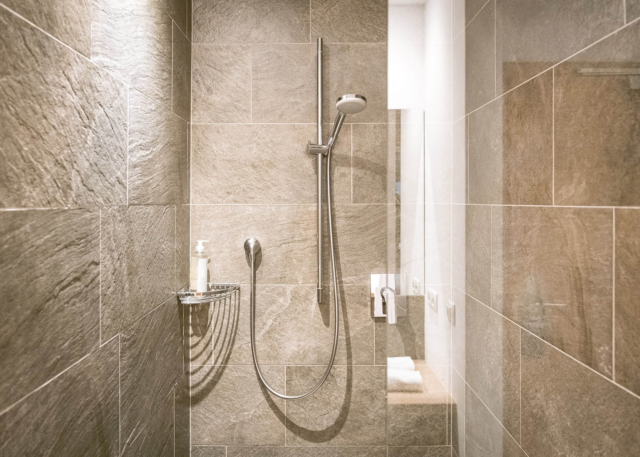 Modern geflieste Dusche mit Regendusche, Handbrause, Seifenspender und eingebautem Regal. - Hotel La Casies Mountain Living